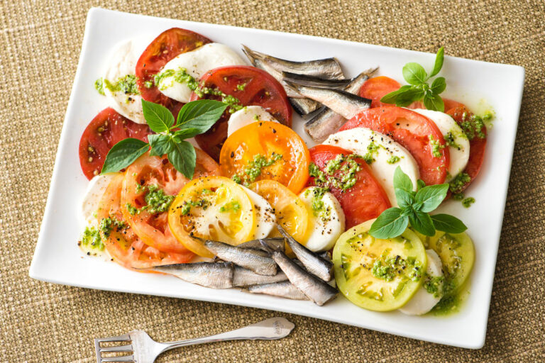 caprese pesto salad with brisling sardines